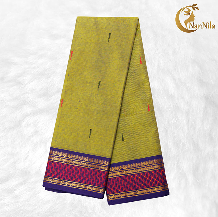 Green saree with purple and gold border on a white background, featuring the NanNila brand.